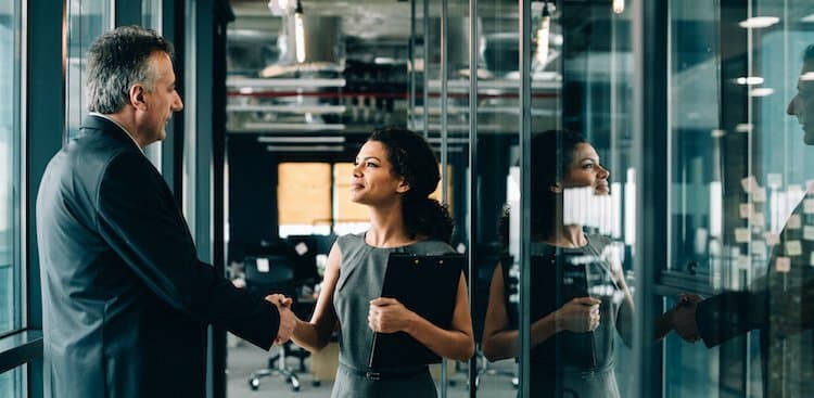 people shaking hands in a sales interview